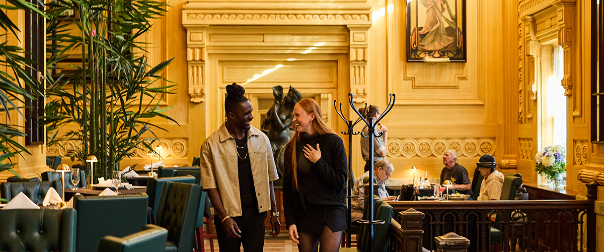 Couple walking through dining room at Pierpont's